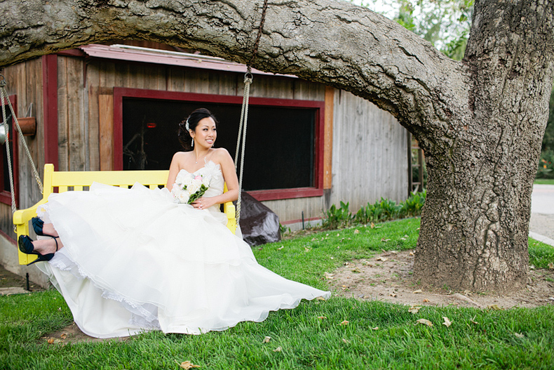 bride on swing at wedding