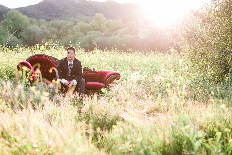 Groom on chaise in middle of field
