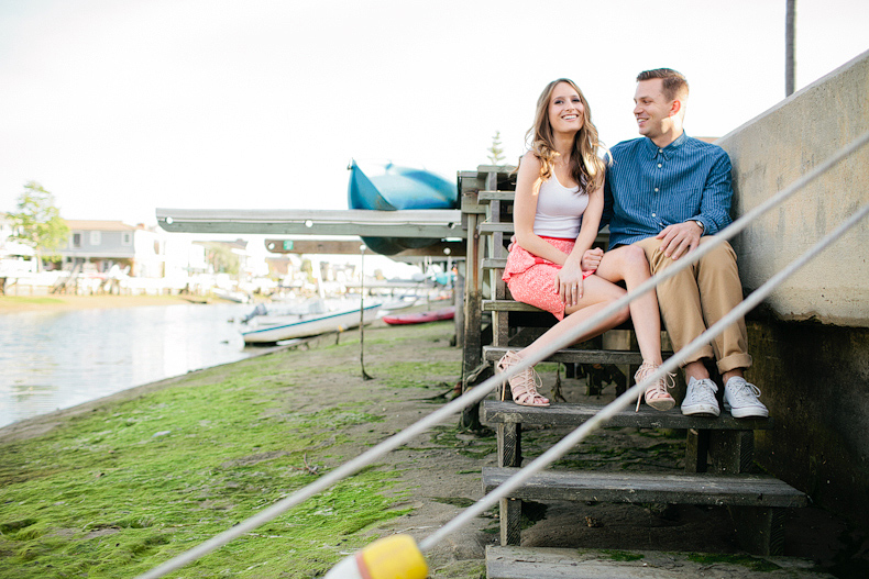bride and groom sitting on balboa dock