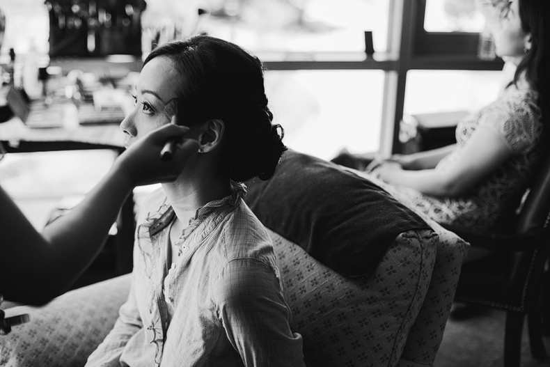 This is a photo of the bride having her makeup done in black and white.