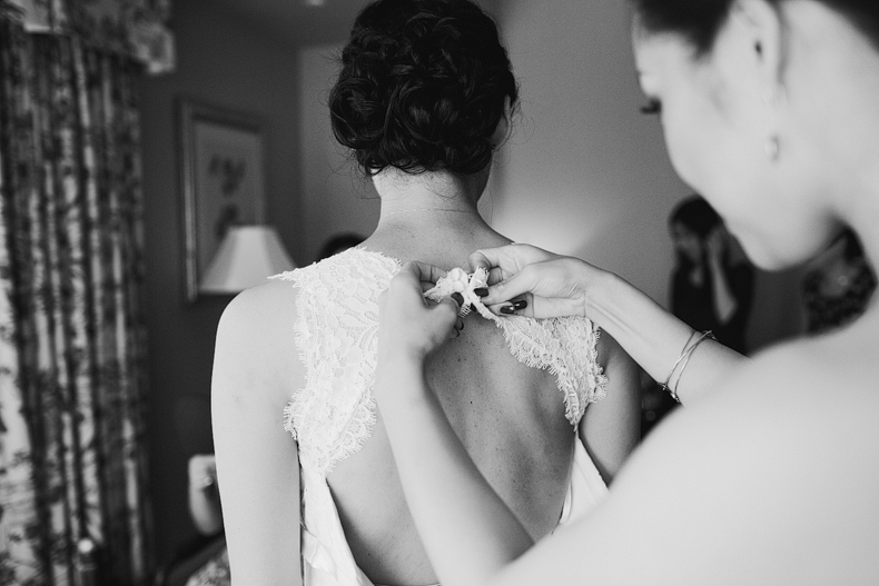 This is a bridesmaid helping the bride put on her dress at the Hyatt in Westlake Village.