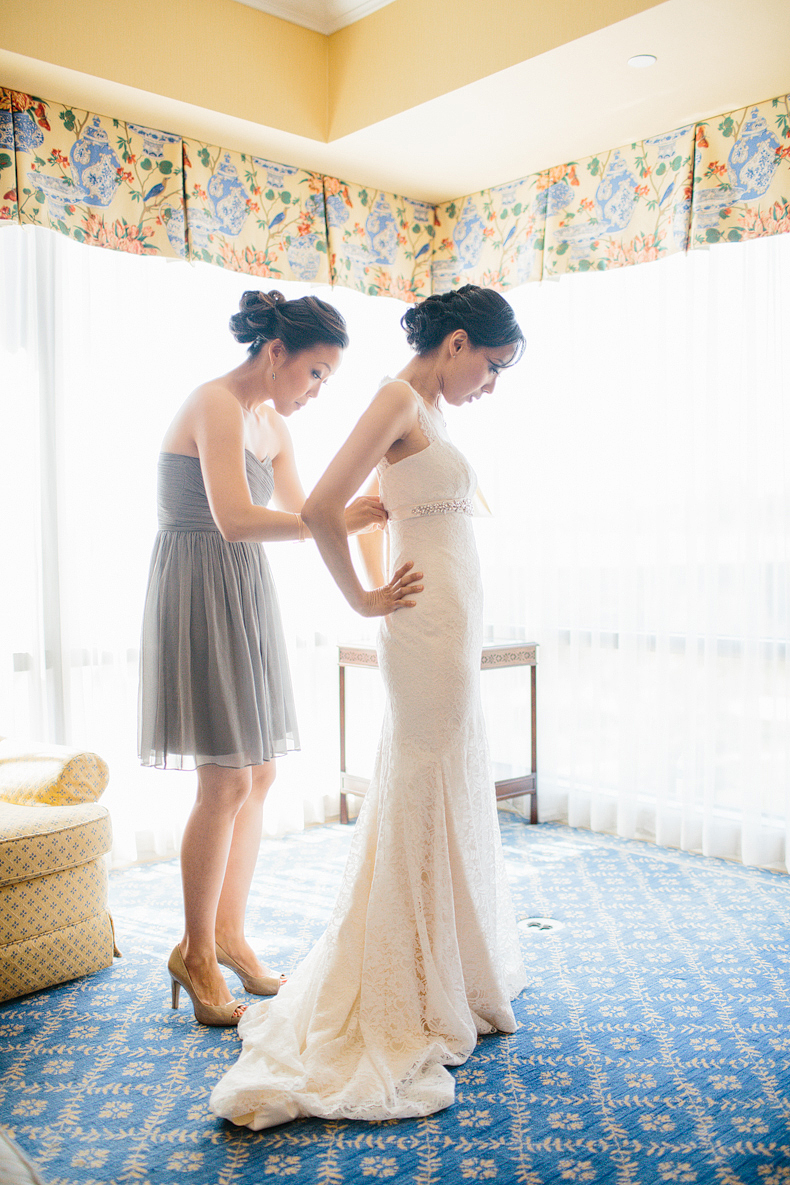 This is a photo of the bride putting on her dress.
