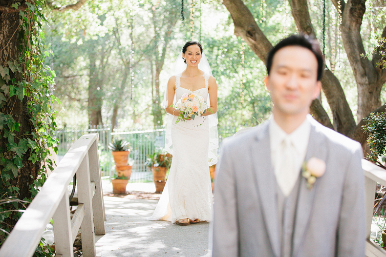 This is a photo of the bride and groom first look on a bridge.