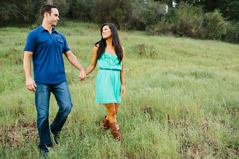 couple walking in a green field