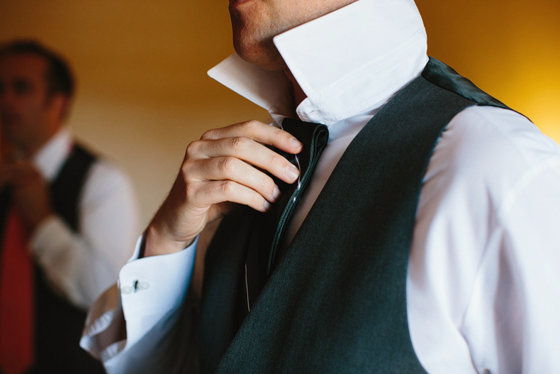 This is a photo of the groom picking which tie to wear for his wedding.