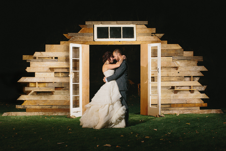 Night time photo of the bride and groom with primary petals awesome backdrop. 