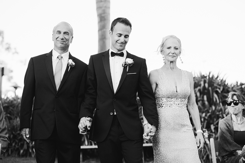 This is the Groom walking down the aisle with his parents.