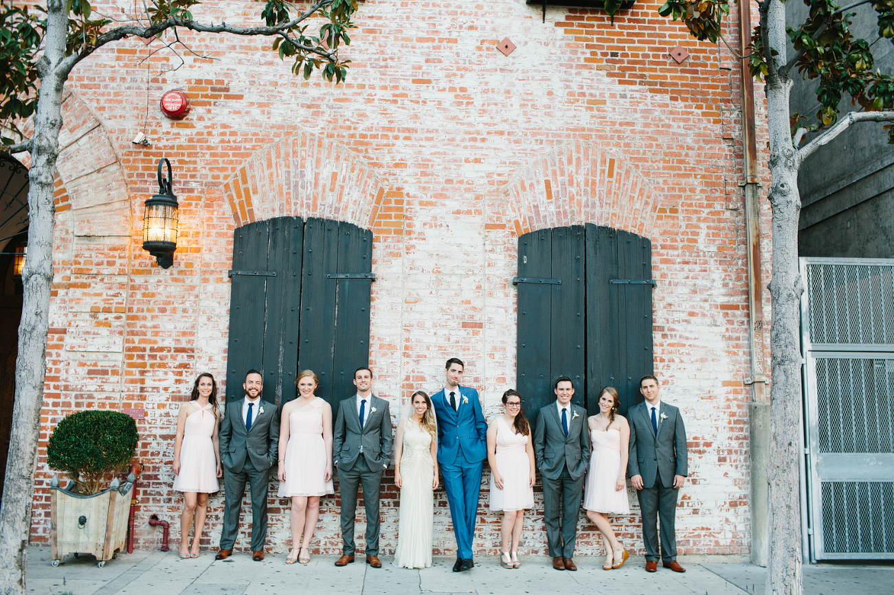This is a full wedding party photo in the front of the venue.