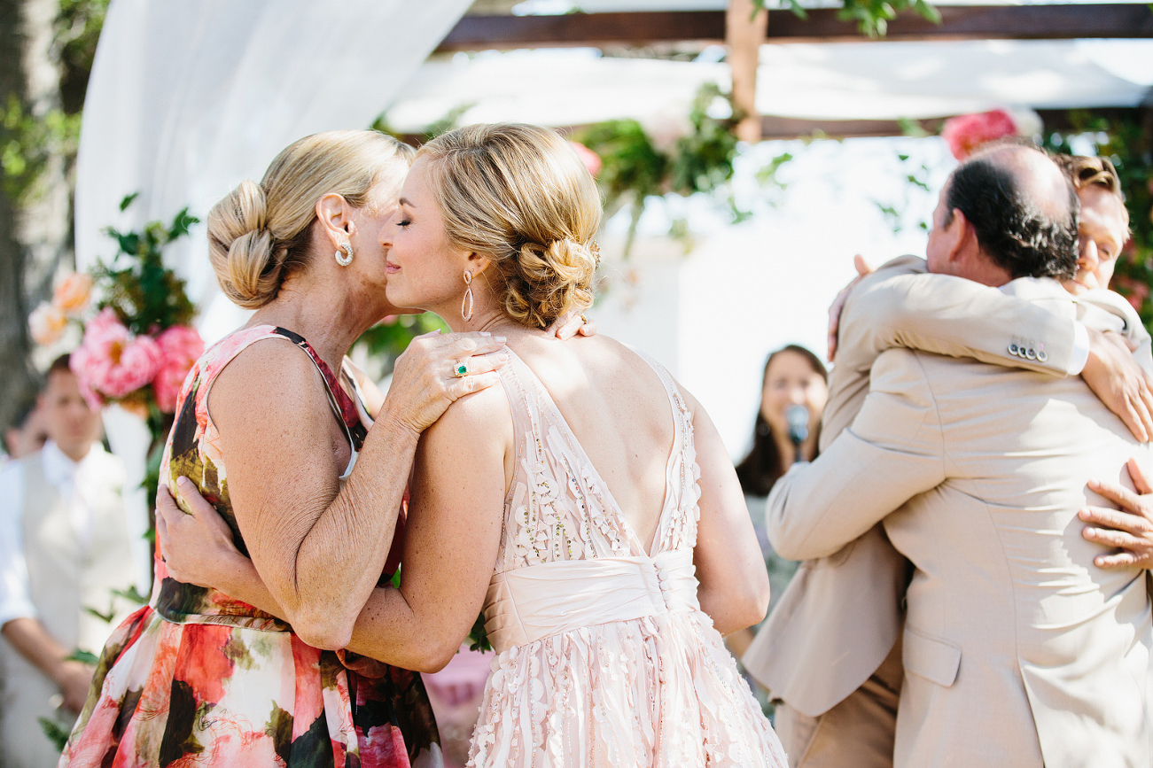 Jess is getting a little kiss from her mom after the processional.