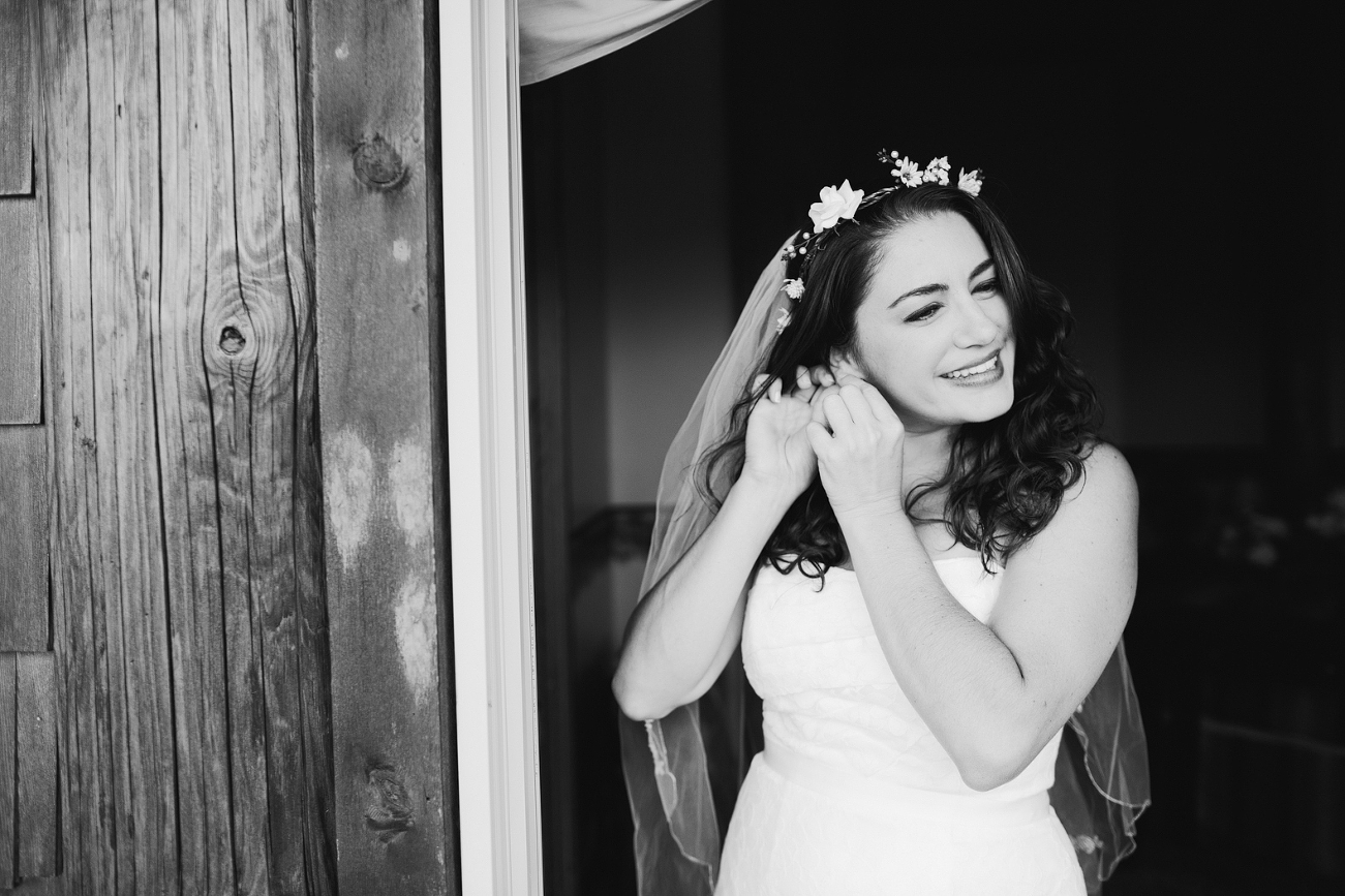 Jenn is putting on her jewelry right before her first look.