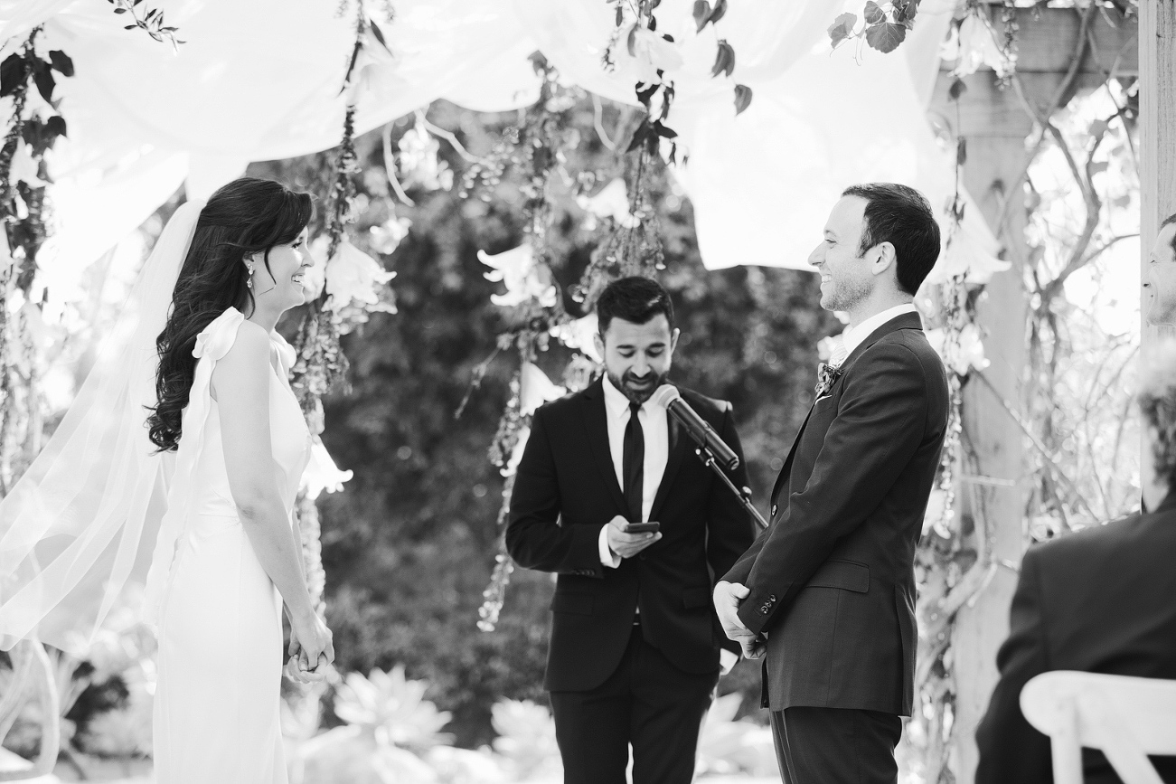 Katy and Andrew smiling during the ceremony. 