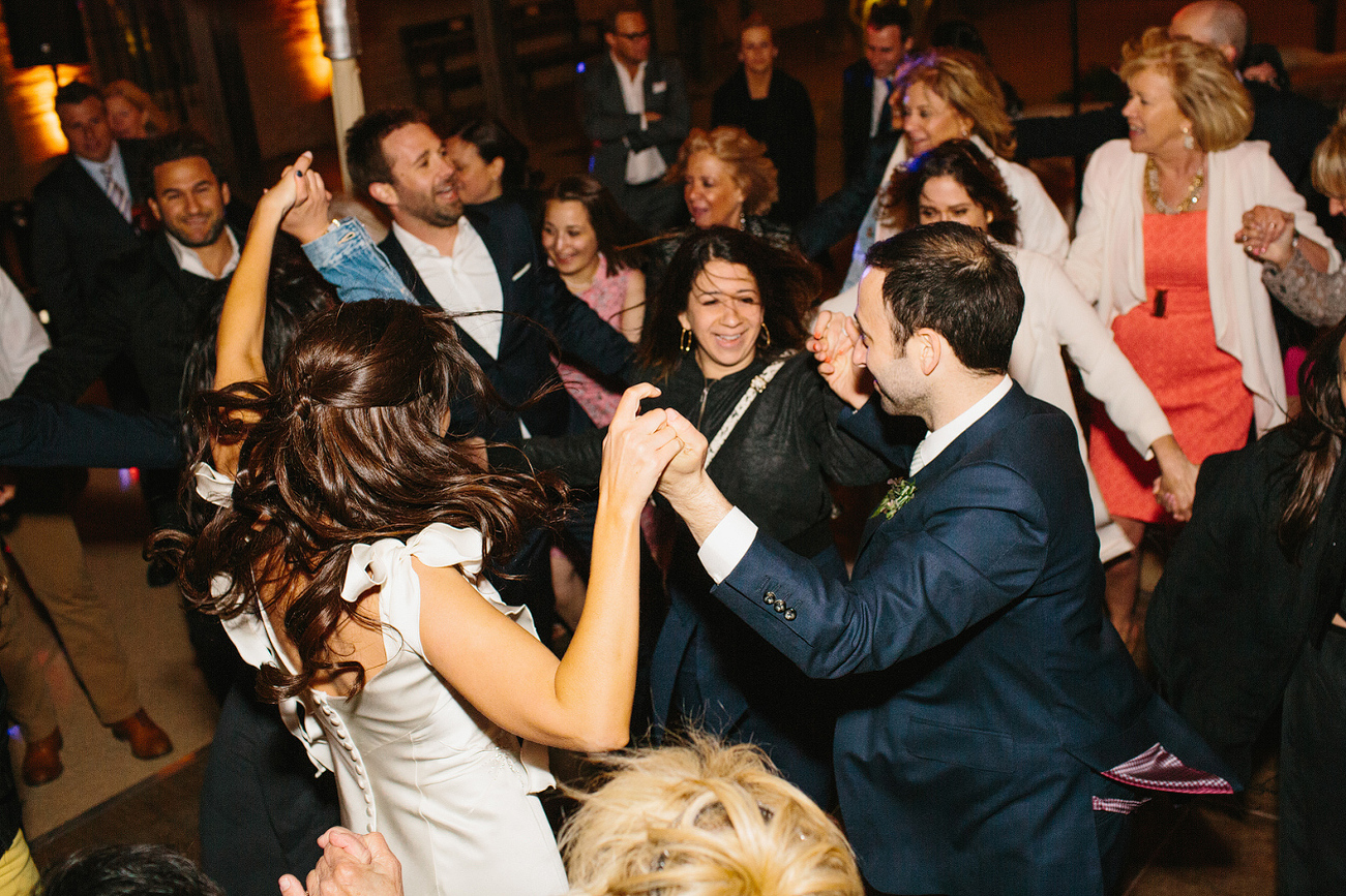 The bride and groom dancing with their friends. 