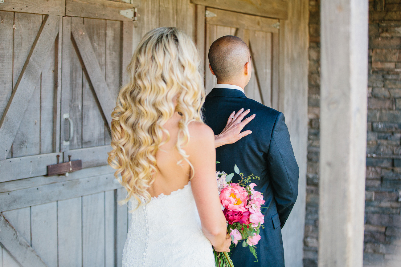 This is a photo of the couple during the first look. 