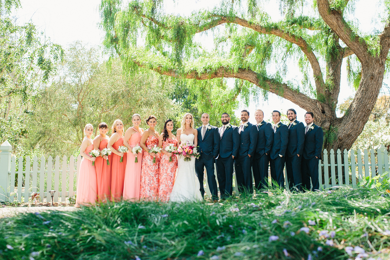 Here is photo of the full wedding party in front of the green pickett fence. 