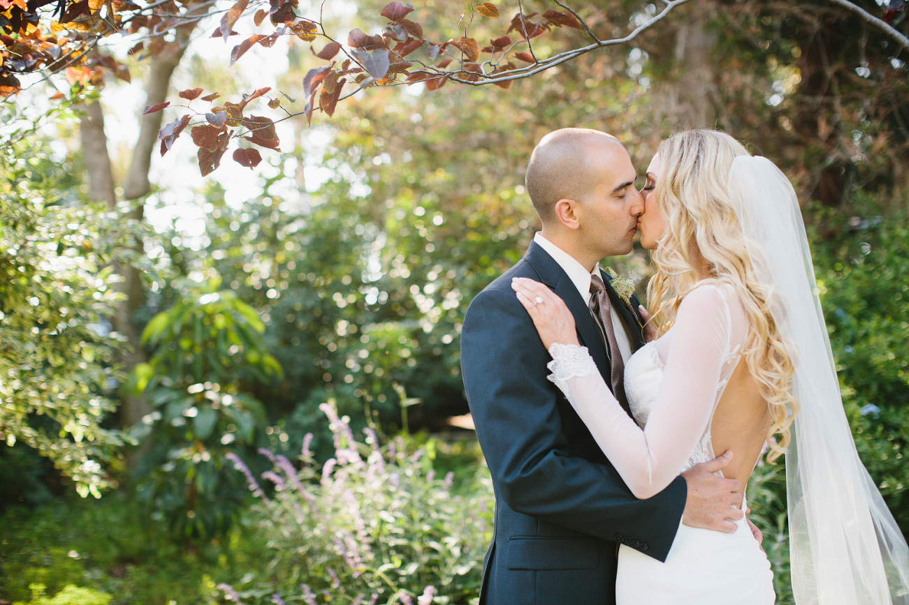 Here is a photo of the bride and groom kissing after their ceremony. 
