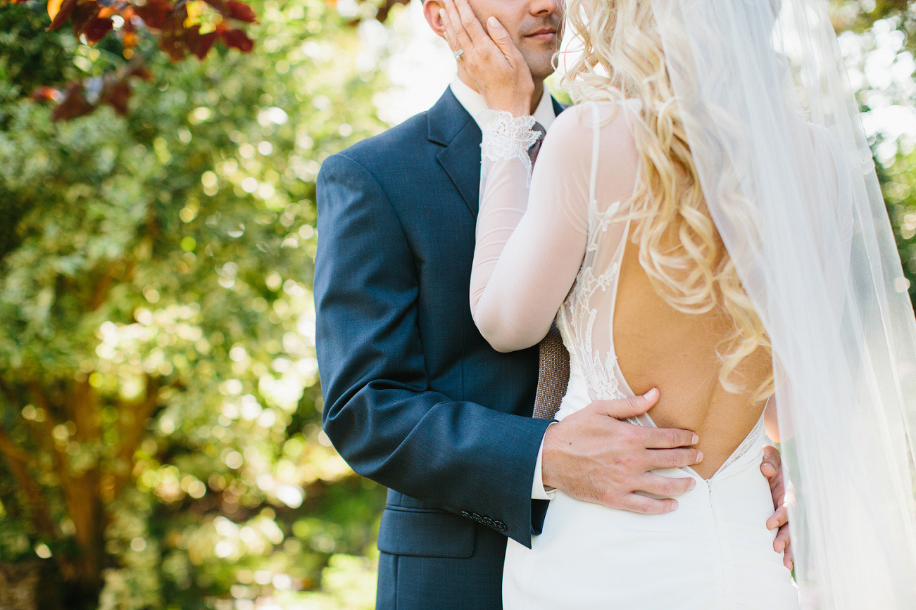 This is a photo of the bride and groom holding each other on their wedding day. 