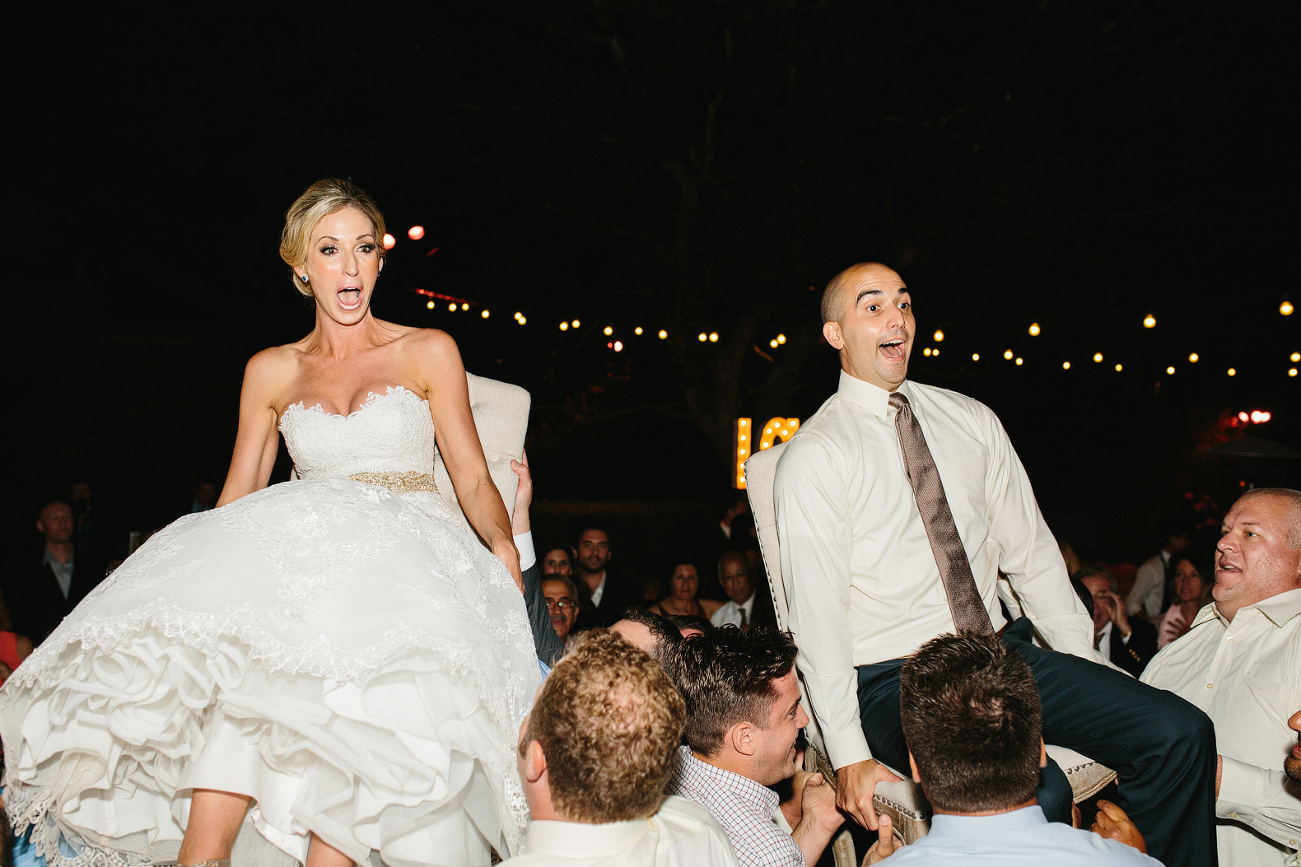 The bride and groom seemed nervous on the chairs. 