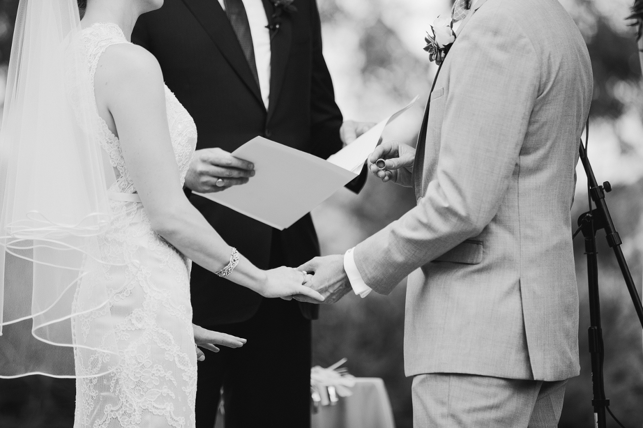 This is a photo of the groom putting on the bride