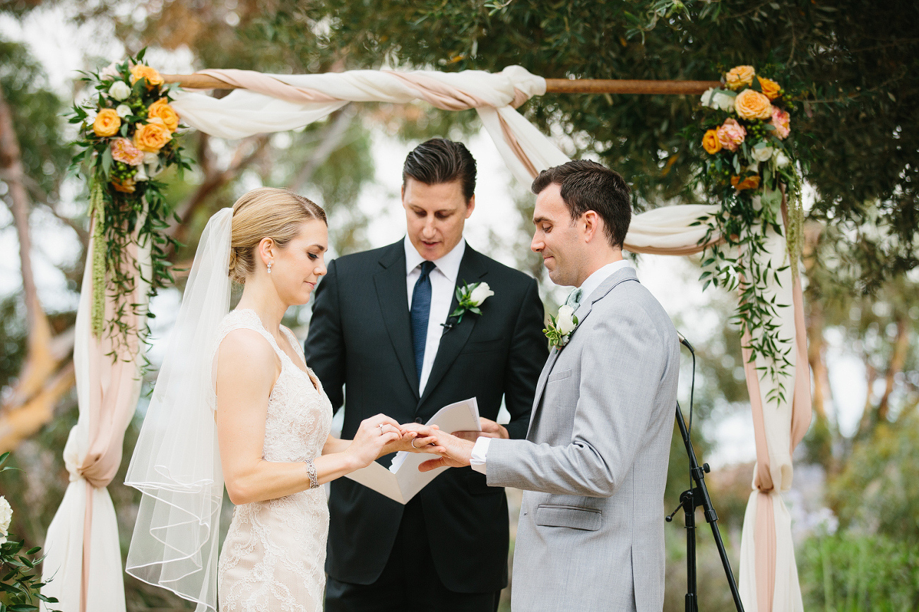 The ceremony backdrop was an arch with flowers and fabric. 