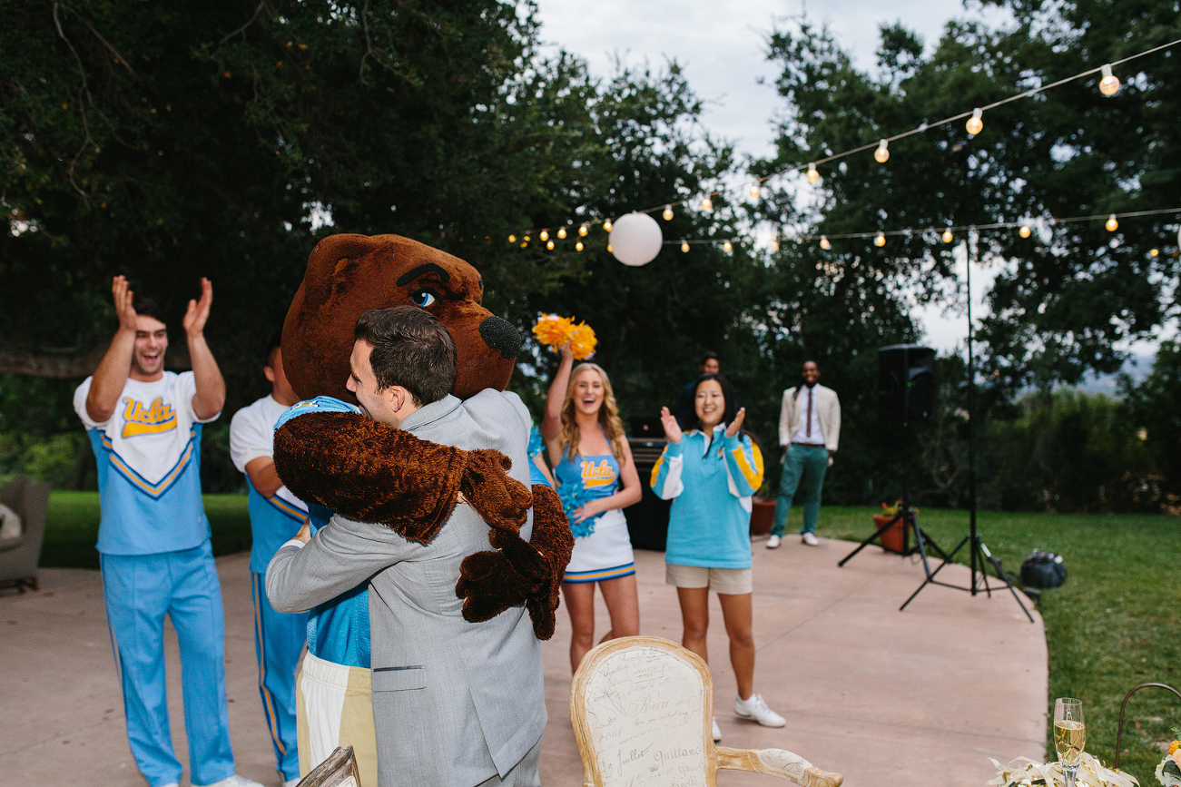 The mascot gave Chris a hug. 