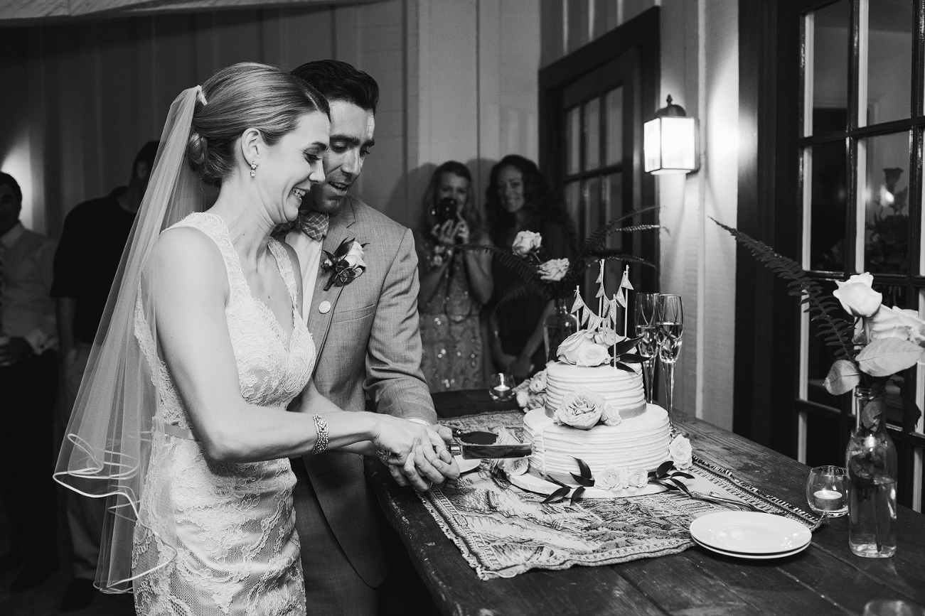 Kelly and Chris cut the wedding cake. 