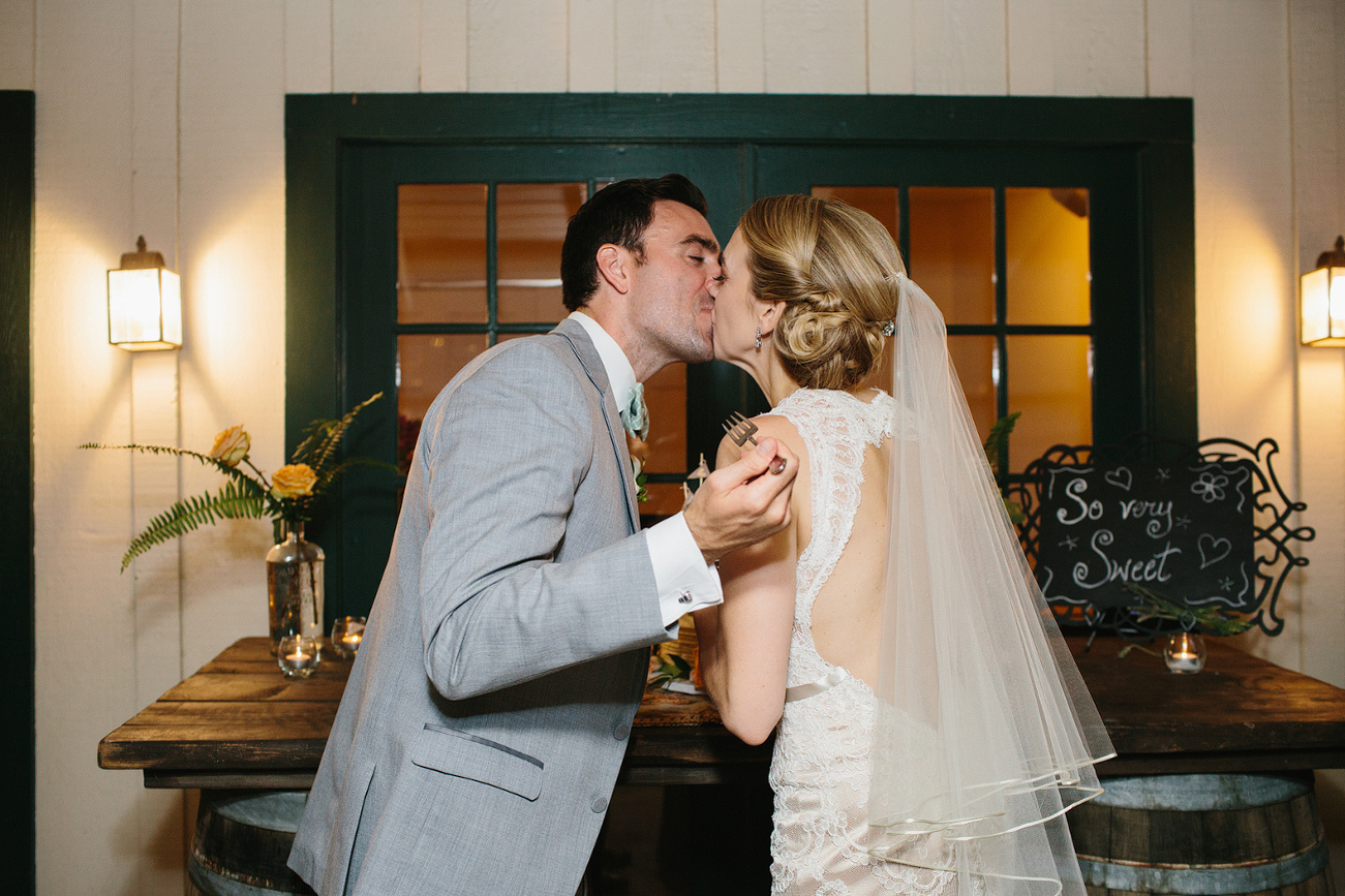 Here is a cute photo of the bride and groom kissing after cake cutting. 