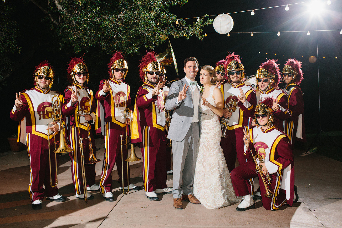 This is a photo of the bride and groom with the USC marching band. 