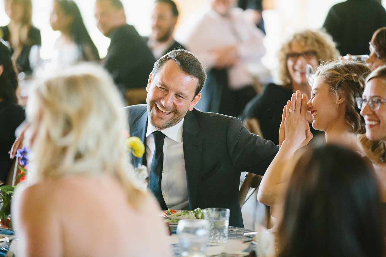 Caitlin and Dan laughing during toasts. 