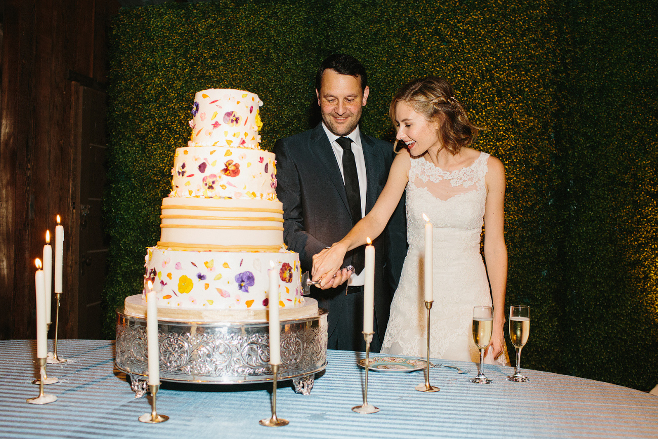 The bride and groom cutting the cake. 