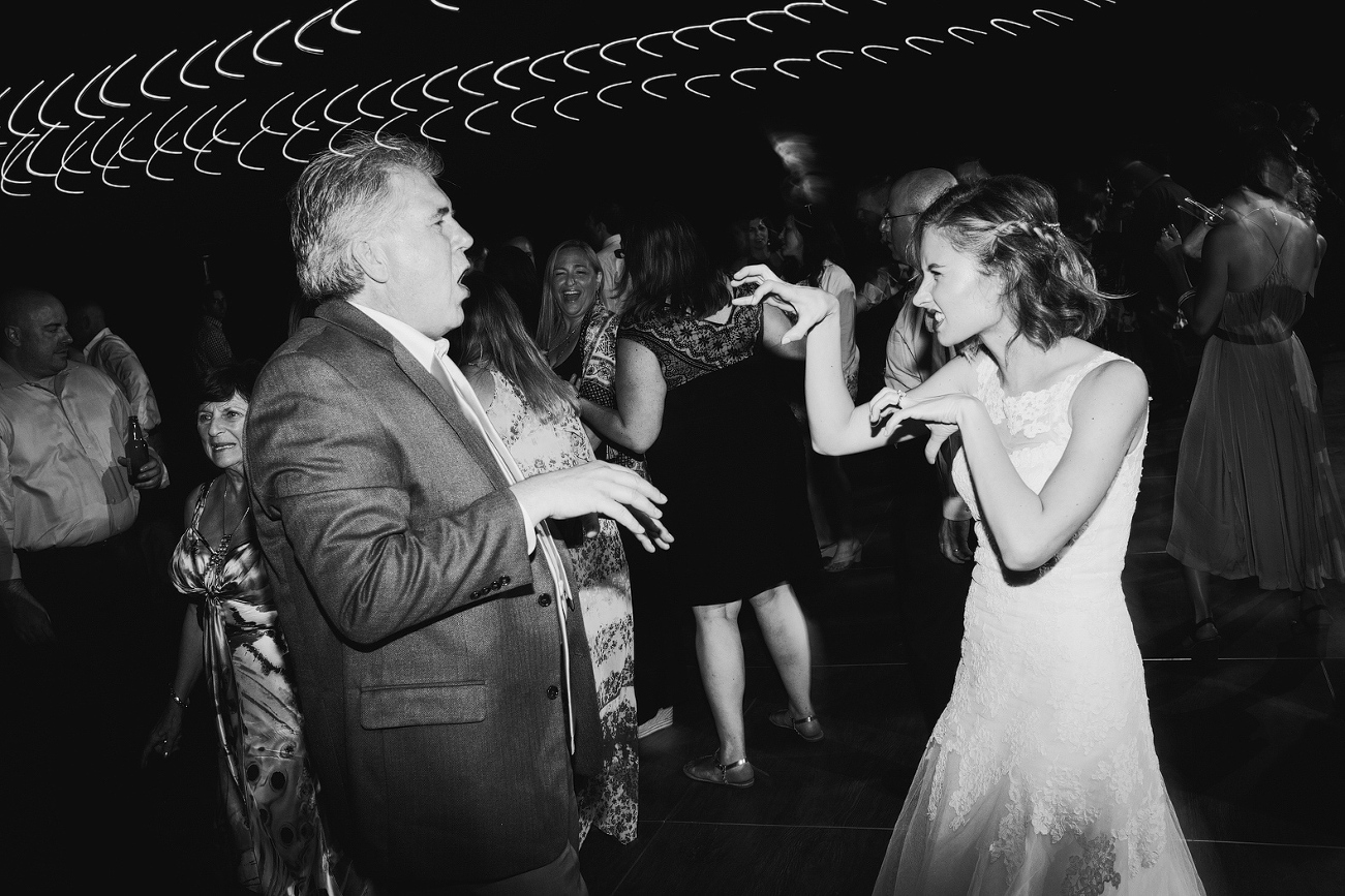 A photo of Caitlin dancing with a guest. 