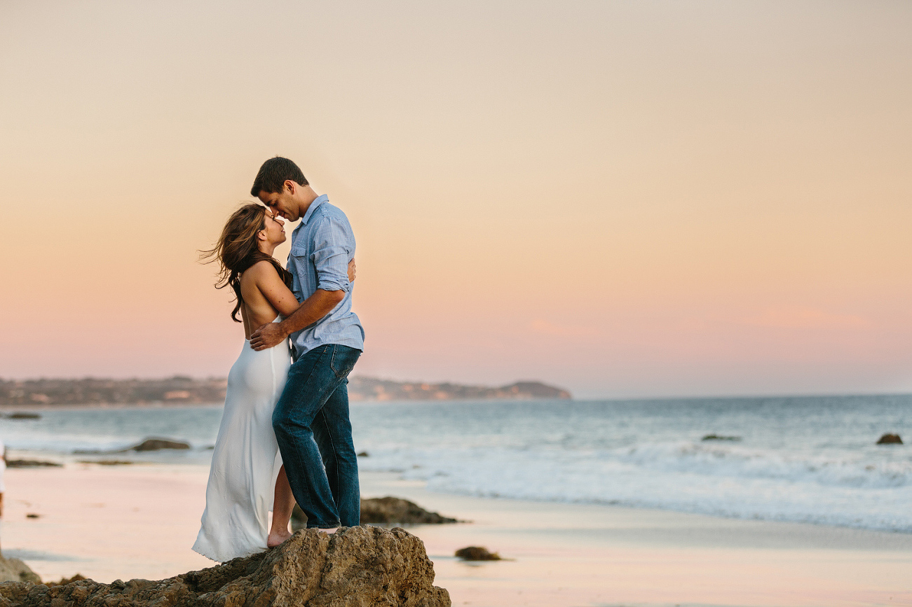 A beautiful photo of Sara and Sam on beach rocks. 