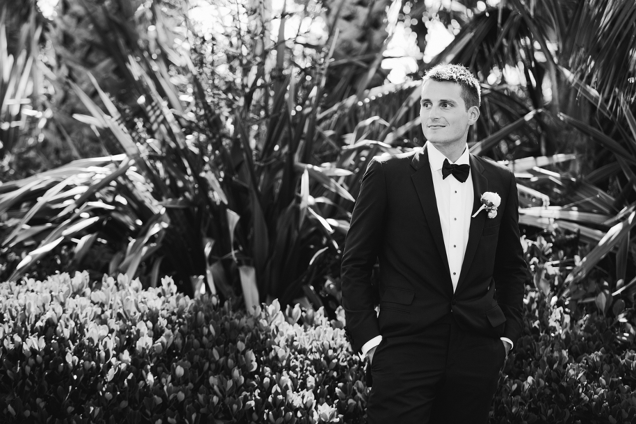 A black and white shot of the groom. 
