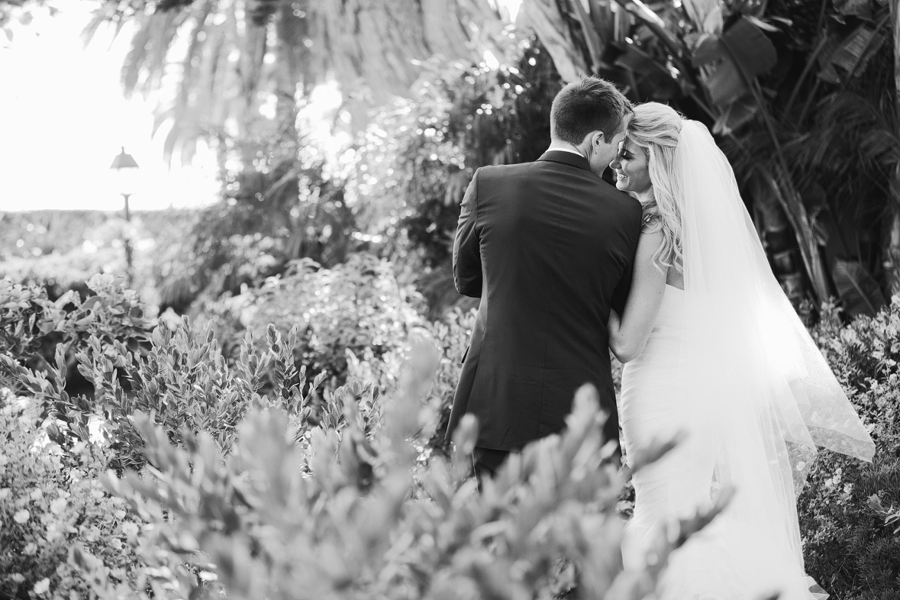 A beautiful black and white photo of the bride and groom walking. 