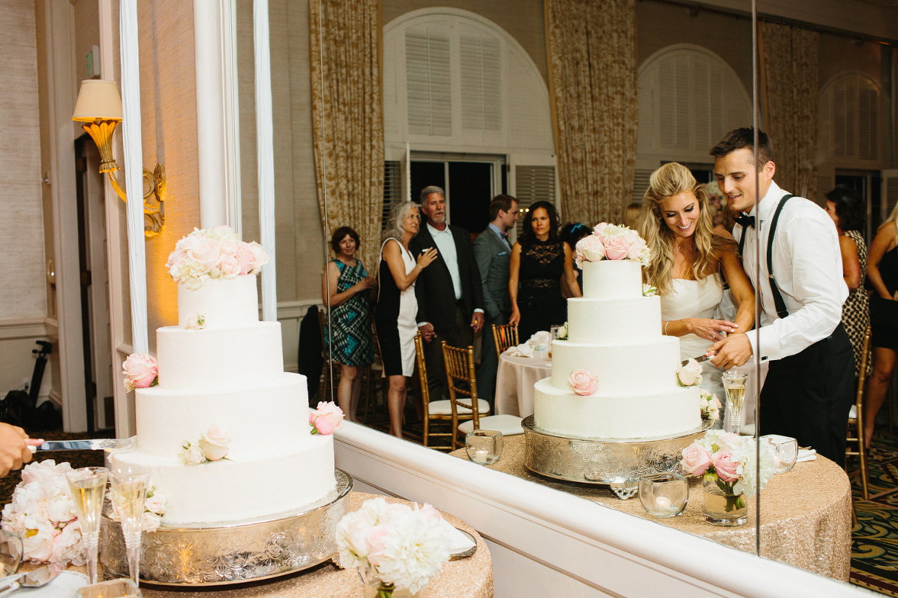 A cool shot of the bride and groom cutting the cake. 