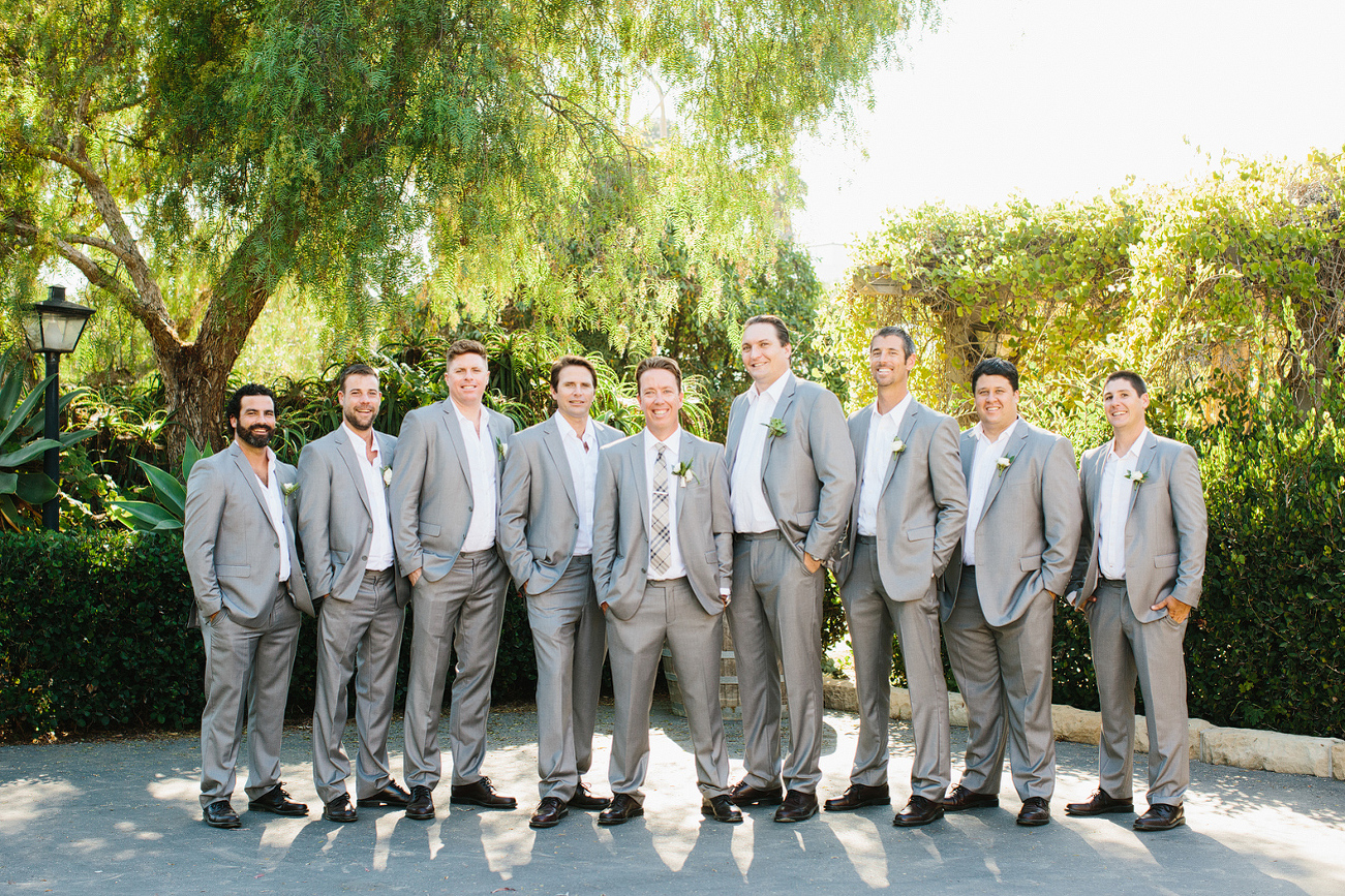 The groom and groomsmen wore gray suits. 