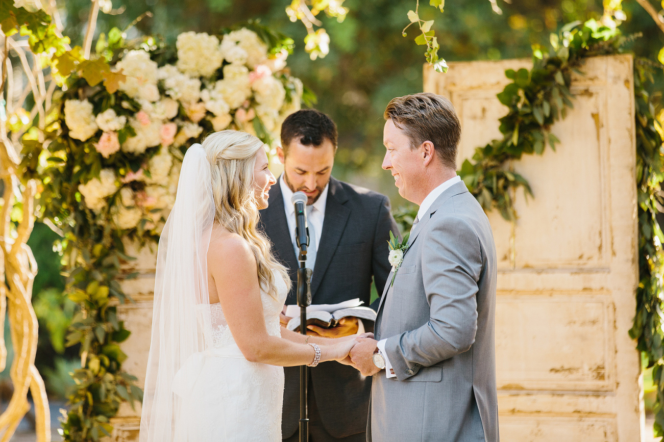 Liz and Chris holding hands during the ceremony. 