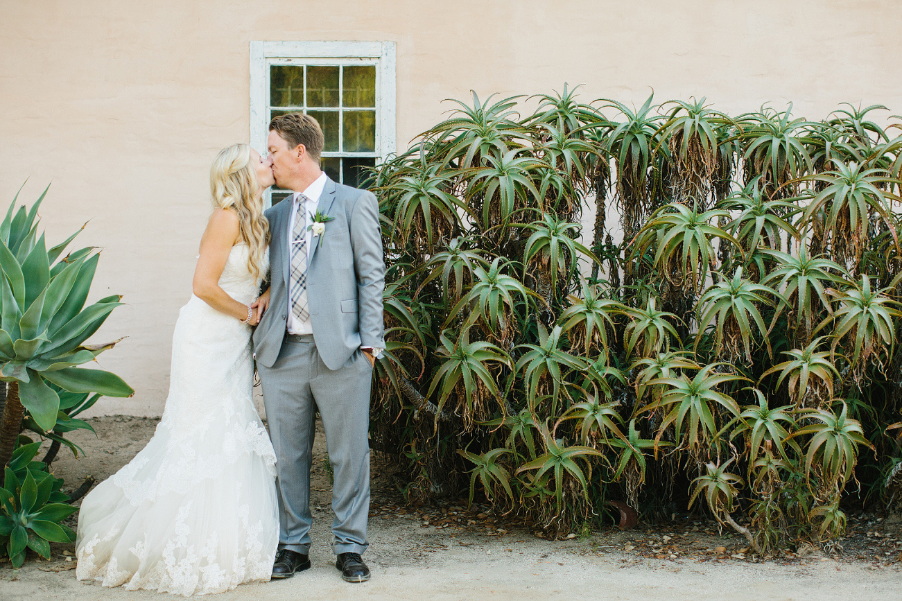 Liz and Chris next to a plant. 