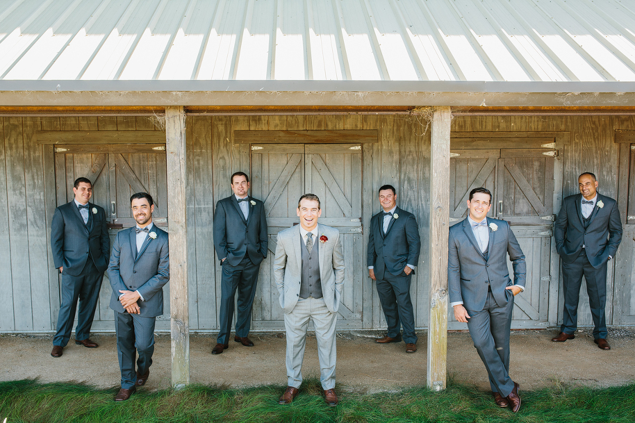 The groom and groomsmen by the barn.
