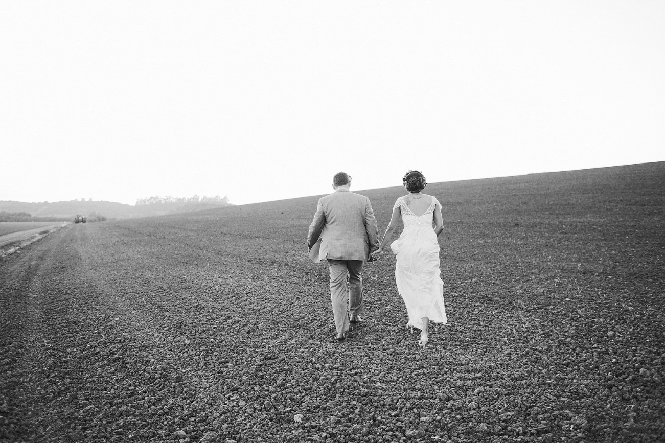 The couple walking in the fields. 