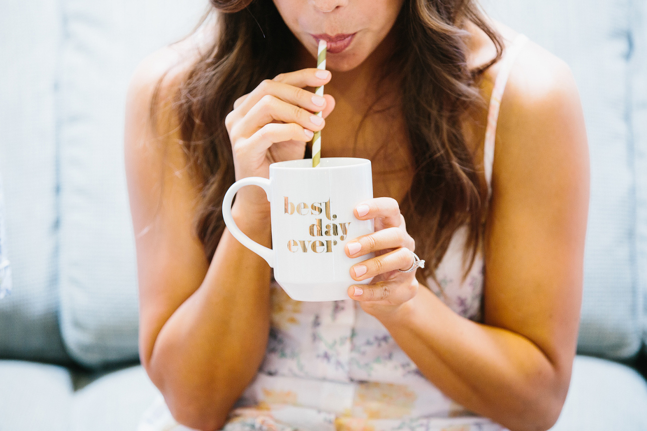 The bride sipping out of a best day ever mug. 
