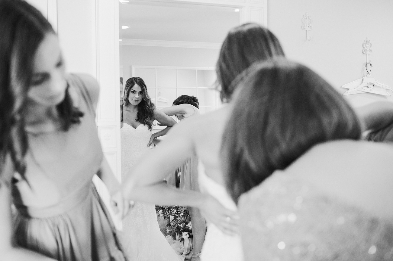 The bride getting in her wedding dress. 