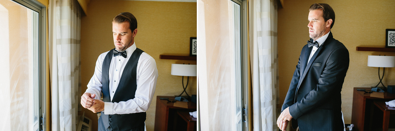 The groom getting in his tuxedo. 