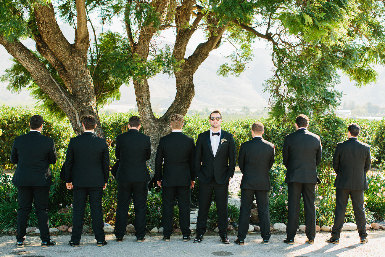 The groom in sunglasseses with the groomsmen. 