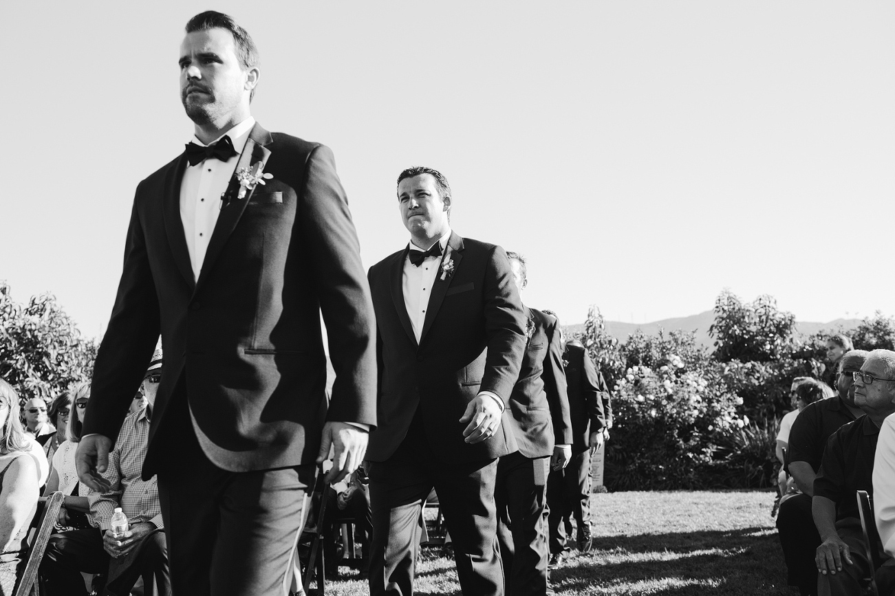 The groom and groomsmen walking into the wedding ceremony. 