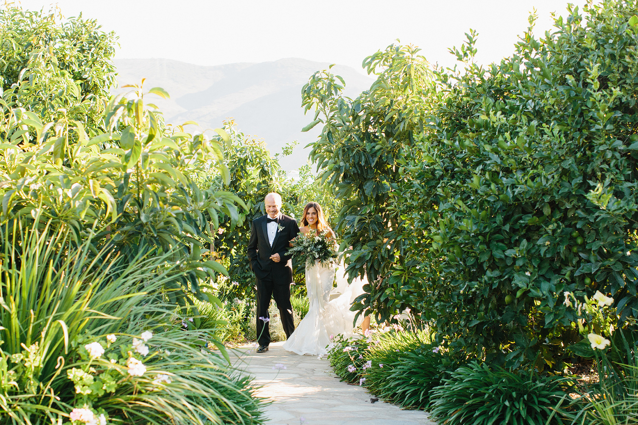 The bride with her father walking into the ceremony. 