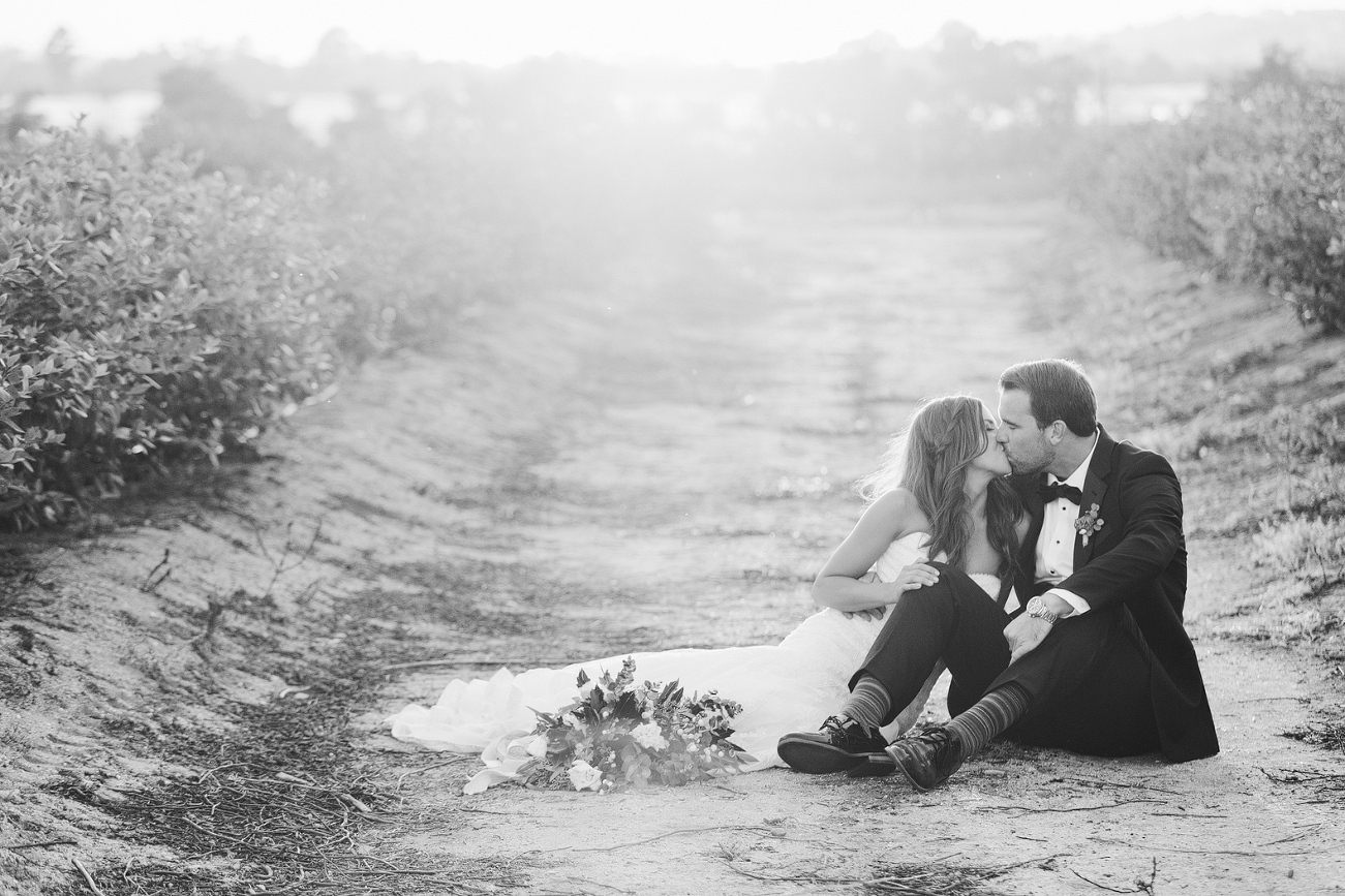 A black and white photo of the couple on a dirt path. 