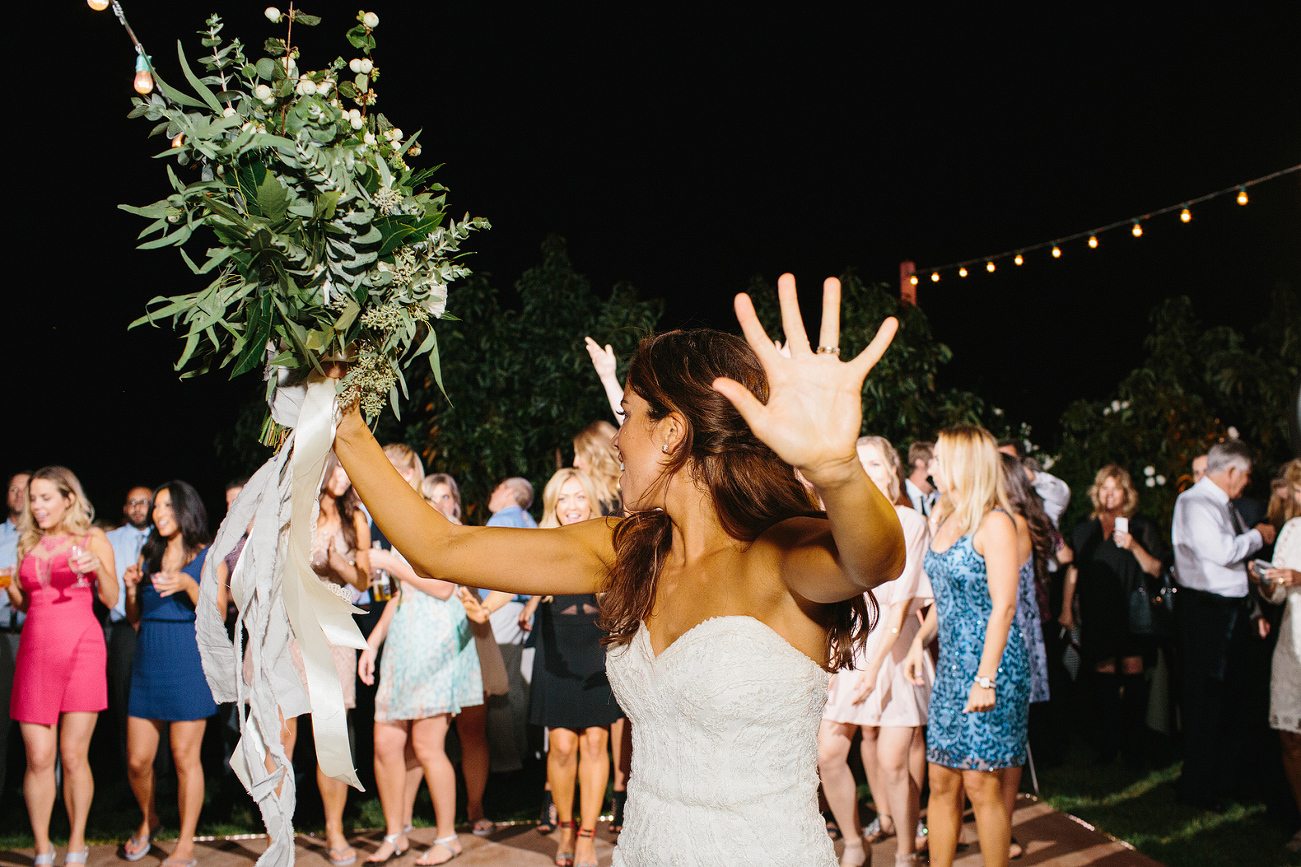 The bride tossing her bouquet. 