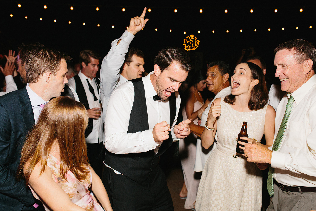 The groom dancing during the reception. 