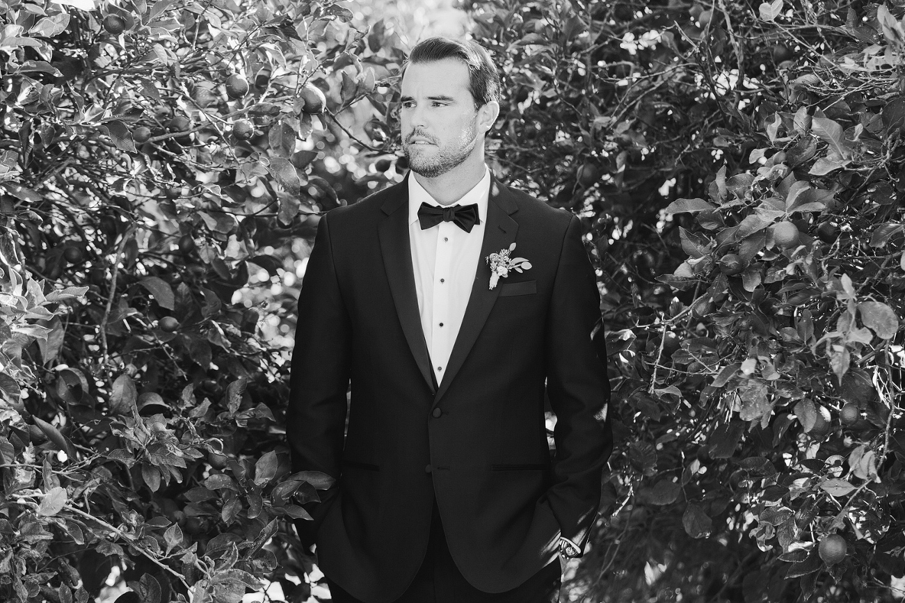 A black and white portrait of the groom. 