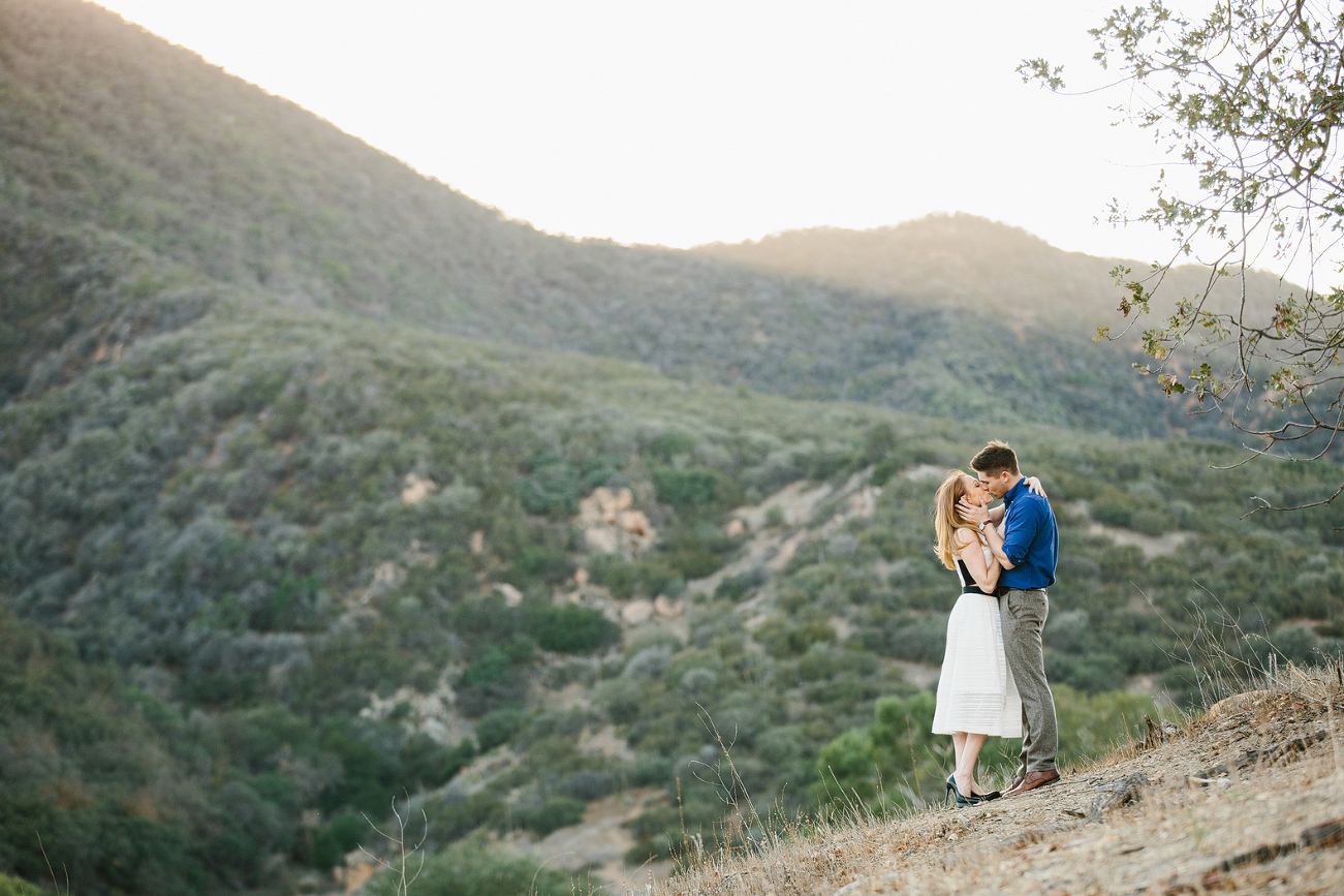 Mallauri and Curt kissing on the hill. 